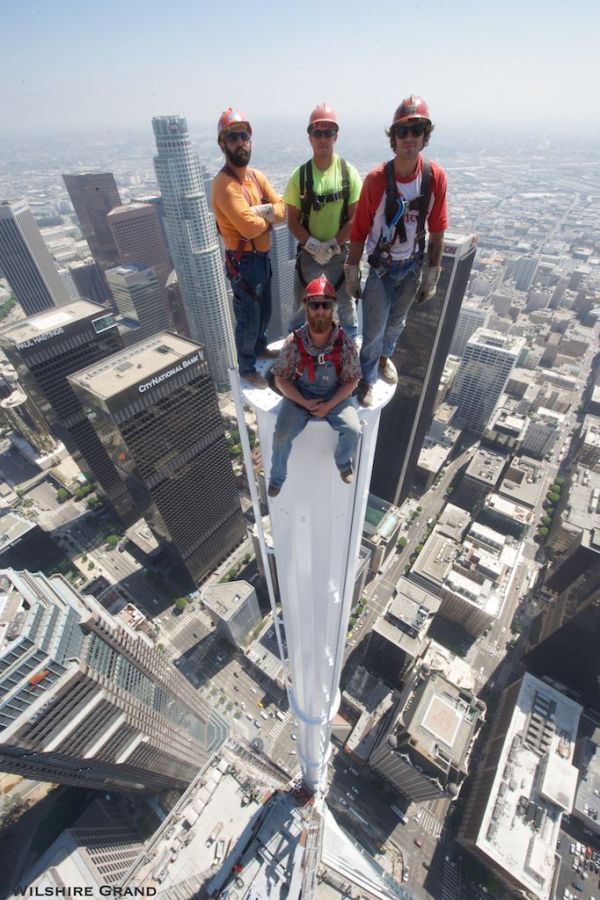 photo-of-four-guys-standing-on-spire-atop-l-a-s-tallest-building